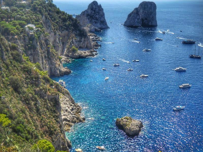 A view of two famous rocks - the ships that go round the island pass right between these rocks - 10 photos that will make you want to visit Capri, Italy