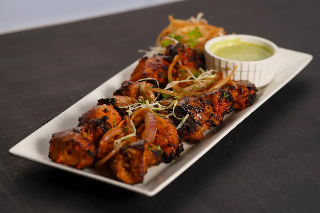 Grilled Chicken Tikka skewers marinated in yogurt and Indian spices, a mild and flavorful North Indian dish perfect for beginners trying Indian food