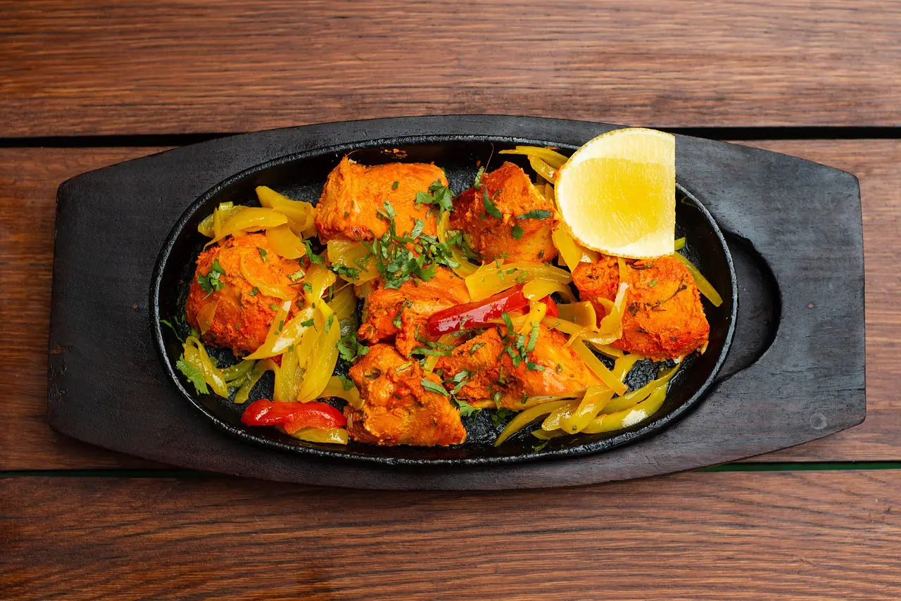 Authentic Chicken Tandoori roasted in a clay tandoor oven with aromatic spices and yogurt, a smoky and spicy classic of Indian cuisine
