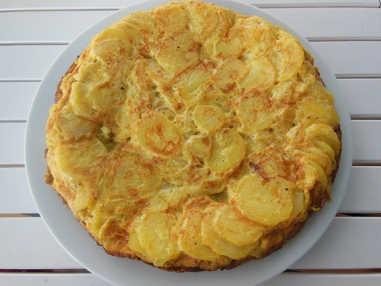 The Tortilla Española, also known as the Spanish omelet, is one of the best Spanish foods to try! Read this article to discover what to eat in Spain, Europe