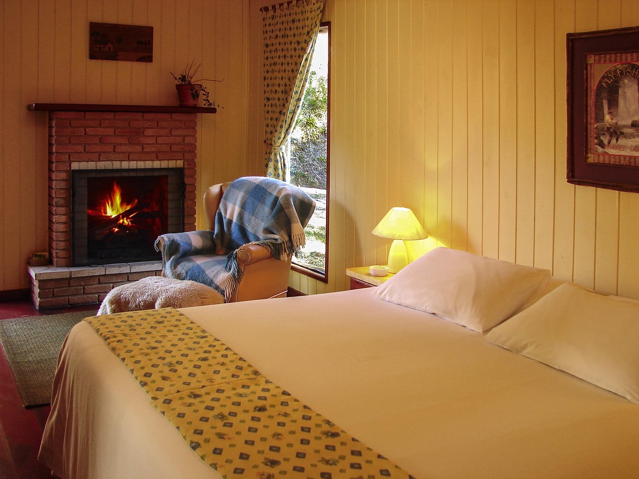 Cozy bedroom with fireplace and warm lamp creating a relaxing nighttime sleep environment for longevity