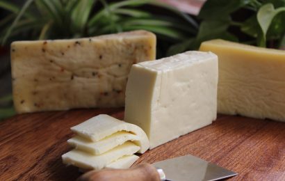 Assorted cheese blocks on a wooden board, linked to new research on cheese consumption and dementia risk