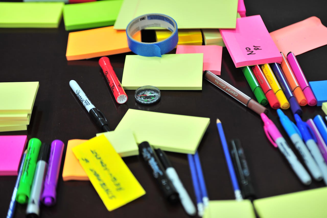 Colorful sticky notes and markers symbolizing overplanning and scattered focus