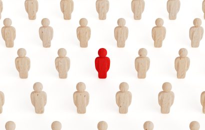 Red figure standing out among crowd – otrovert personality type. The concept of otherness