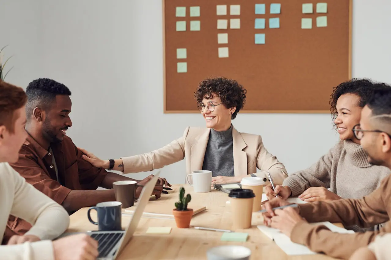 Informal team collaboration where colleagues share ideas and build trust during a group discussion, illustrating natural leadership without a formal title. 14 Science-Backed Signs You’re a Natural Leader