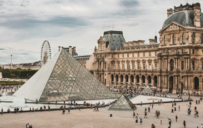 Crowds at the Louvre Pyramid in Paris - Louvre ticket prices rise in 2026