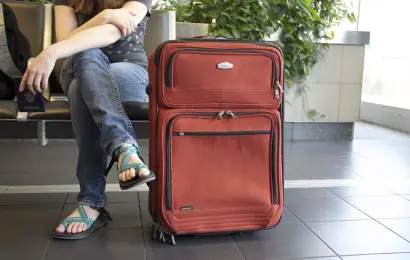 Traveler wearing sandals at an airport — what not to wear on a plane according to flight attendants