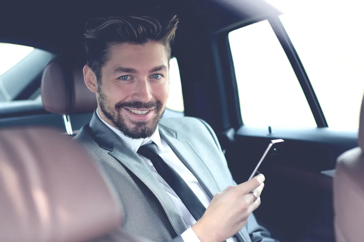 man in a car with a phone, one of the top places people forget their phones