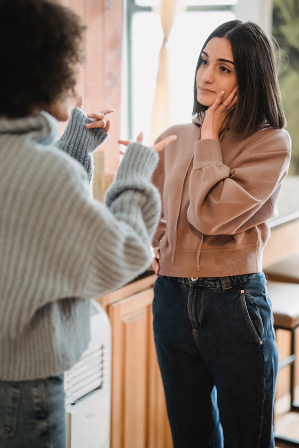 Woman listening to a friend vent during a tense conversation at home