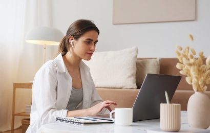 Woman working at laptop - 7 Realistic Ways to Make Extra Money From What You Already Know (Even With 5 Hours a Week)