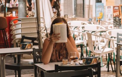 woman reading after eating - The "Sobremesa": Why the Spanish Do Not Eat at Their Desks