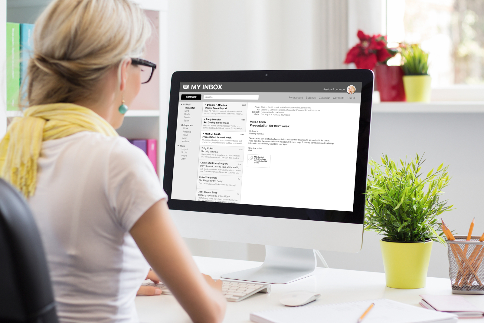 Businesswoman reading an email on her computer, representing follow-up messages and professional communication