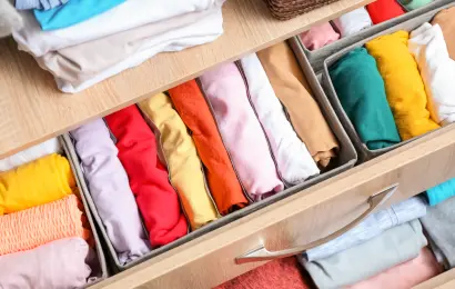 Rolled clothes arranged in a drawer for Sunday outfit planning and an easier week