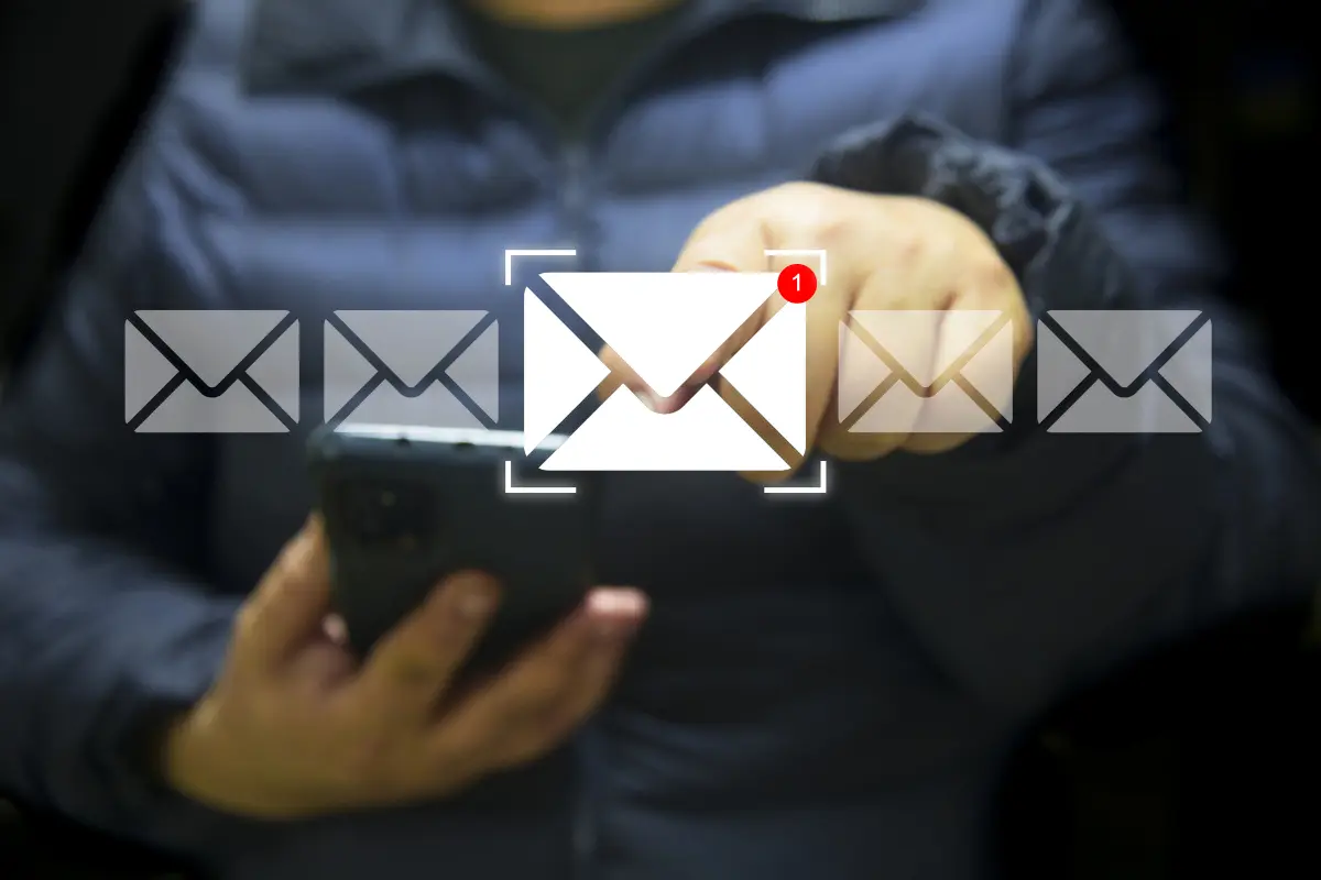 Woman working on a laptop with an email notification icon, illustrating follow-up emails and unread messages