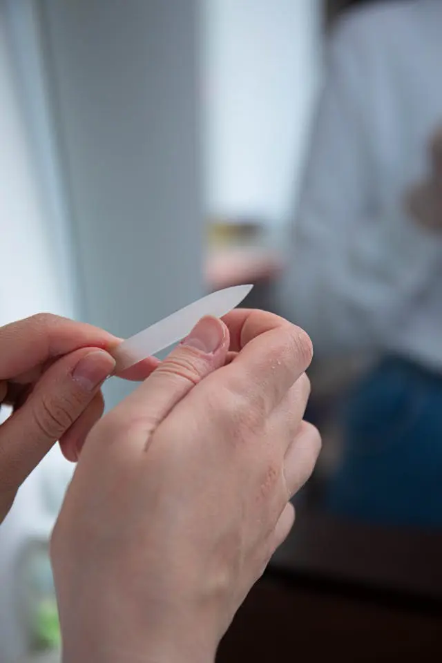 person doing nail filing