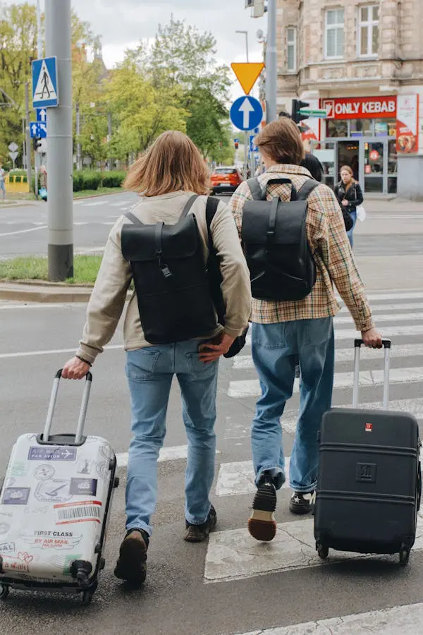 Travelers walking through a European city with rolling carry-on suitcases — a common travel habit that can create noise issues in some historic areas.