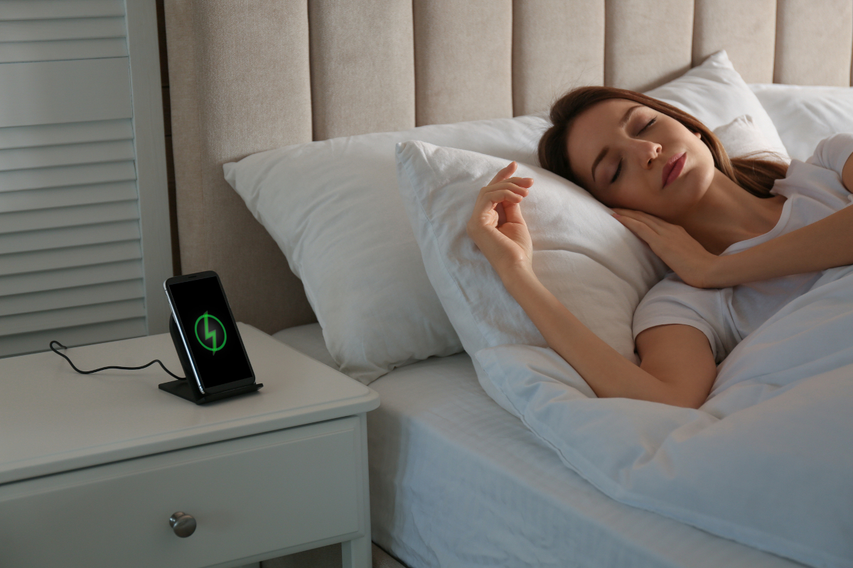 Phone charging on hotel nightstand before hotel checkout