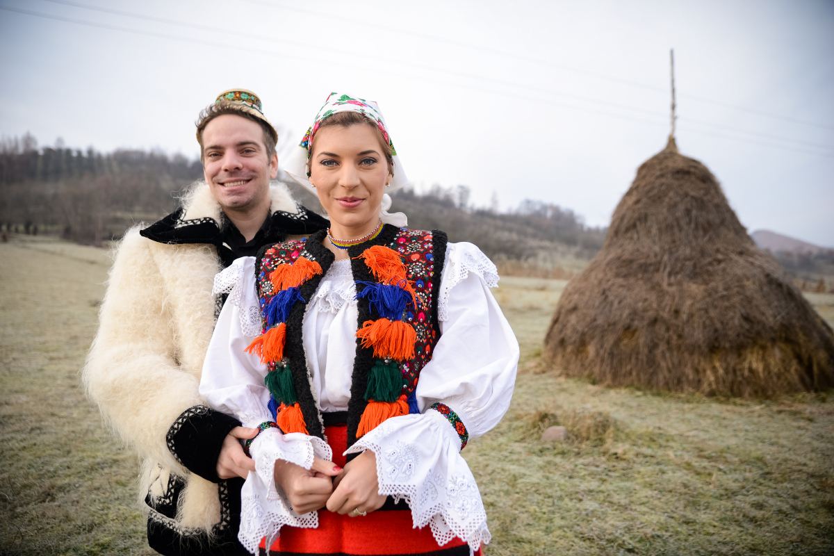 Romanian couple in traditional costumes for a section about Romanian sayings on love family and community