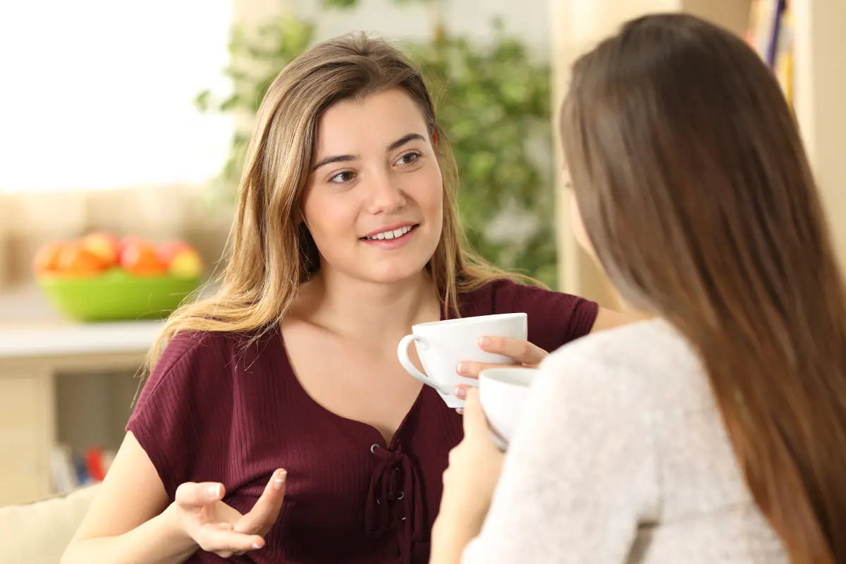 Two friends having a serious but calm conversation over coffee