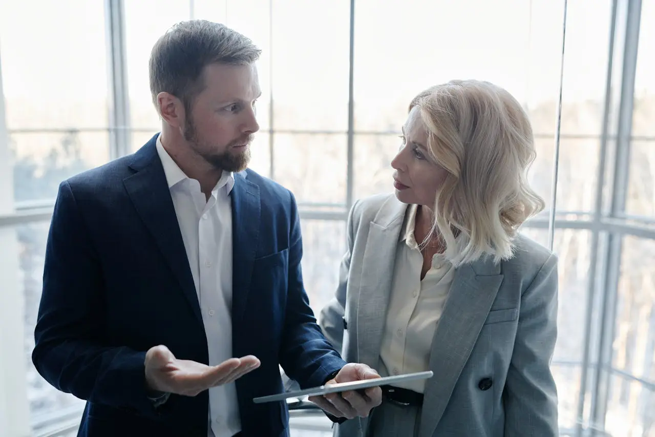 Coworkers having a serious workplace conversation about advice, feedback, and professional boundaries