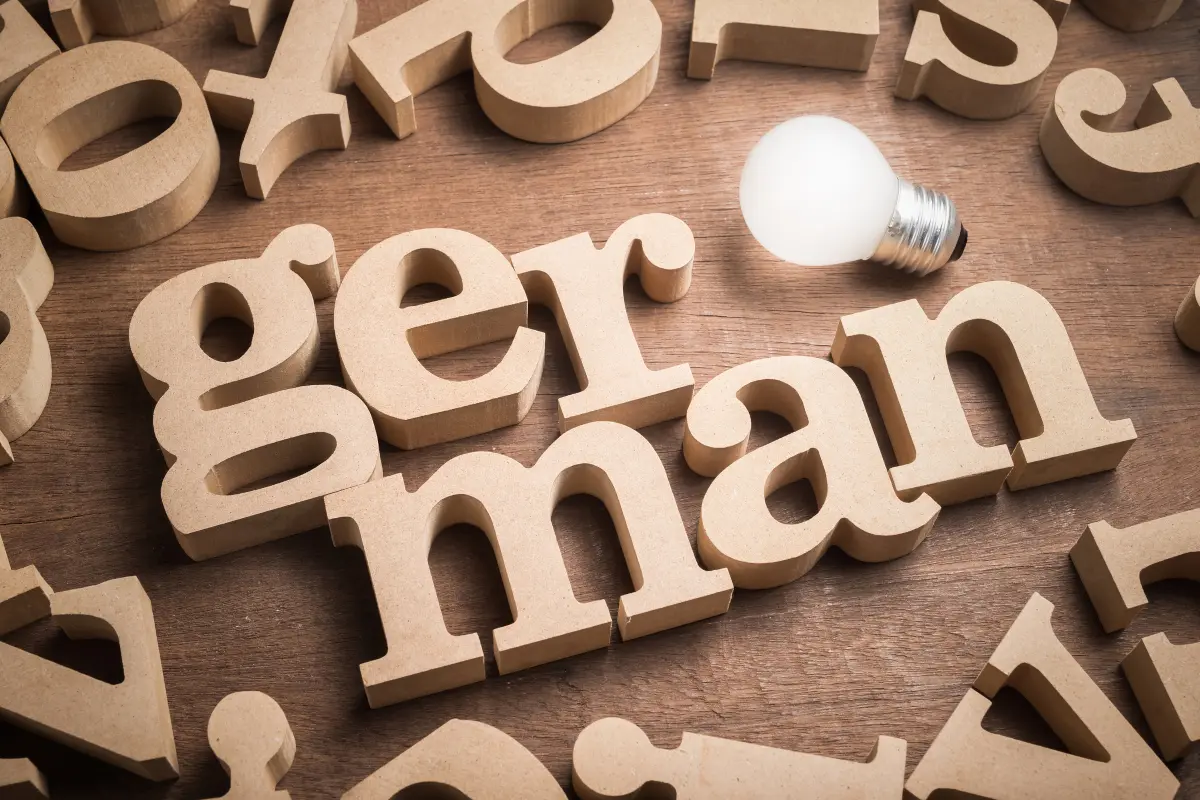 German language learning concept with wooden letters and a light bulb