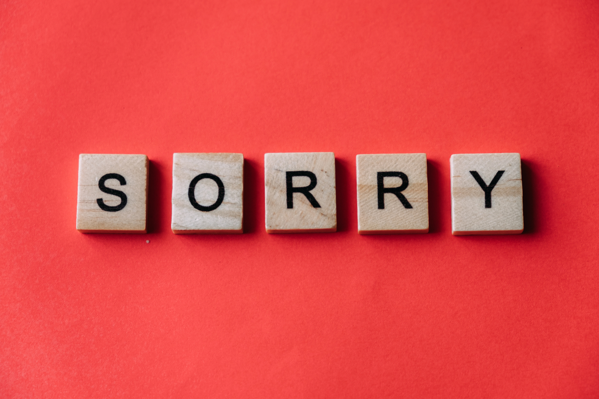The word sorry in letters on wood