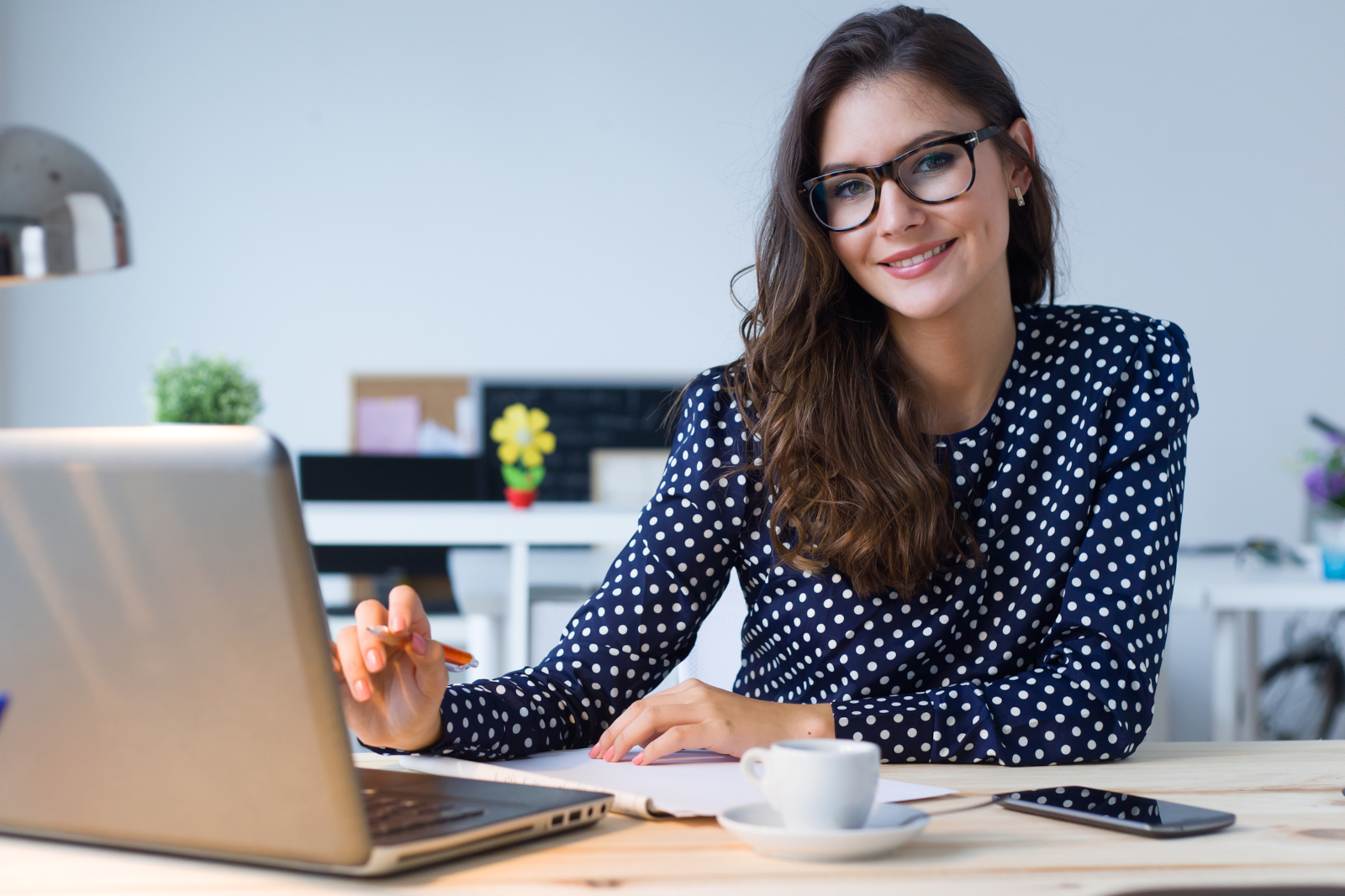 Woman working on a low-cost online business from her laptop