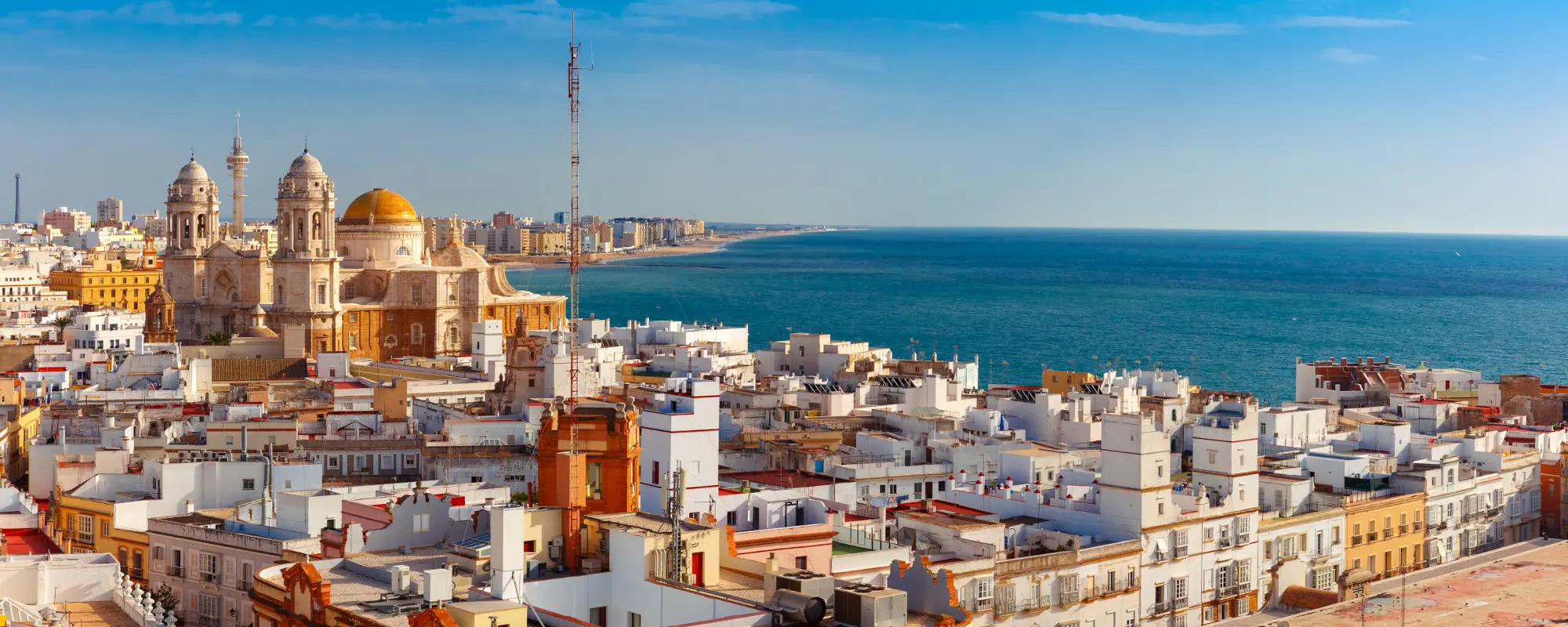 Rooftops and Cathedral in Cadiz, Andalusia, Spain. Aerial panoramic view of the old city rooftops and Cathedral de Santa Cruz in the morning from tower Tavira in Cadiz, Andalusia, Spain - Spain quiz - 175 trivia Spain questions with answers