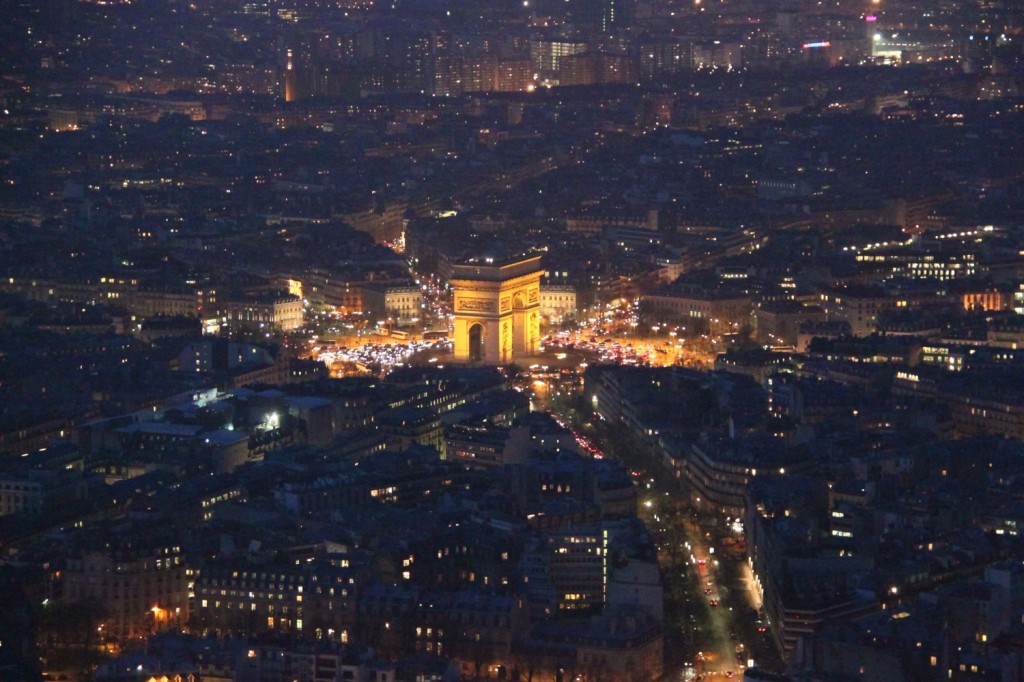 Arc de Triomphe and Paris streets seen at night from the Eiffel Tower second floor