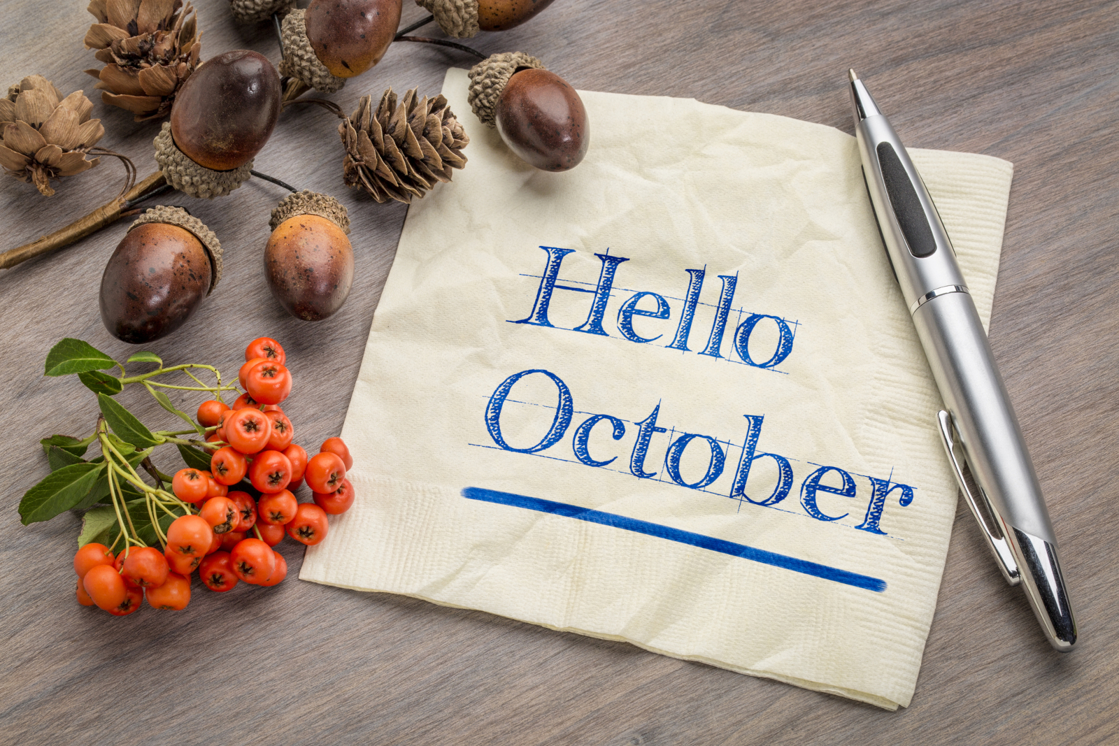 Hello October sign with acorns and autumn decorations