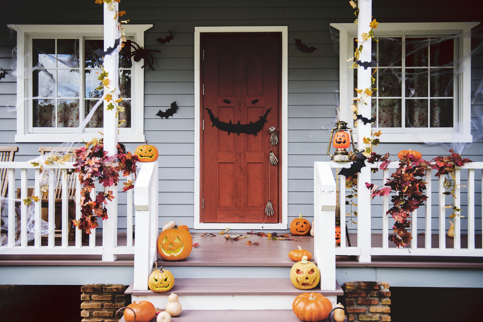 Halloween pumpkins and decorations outside a house For an article with 75 Halloween Facts You Probably Didn't Know