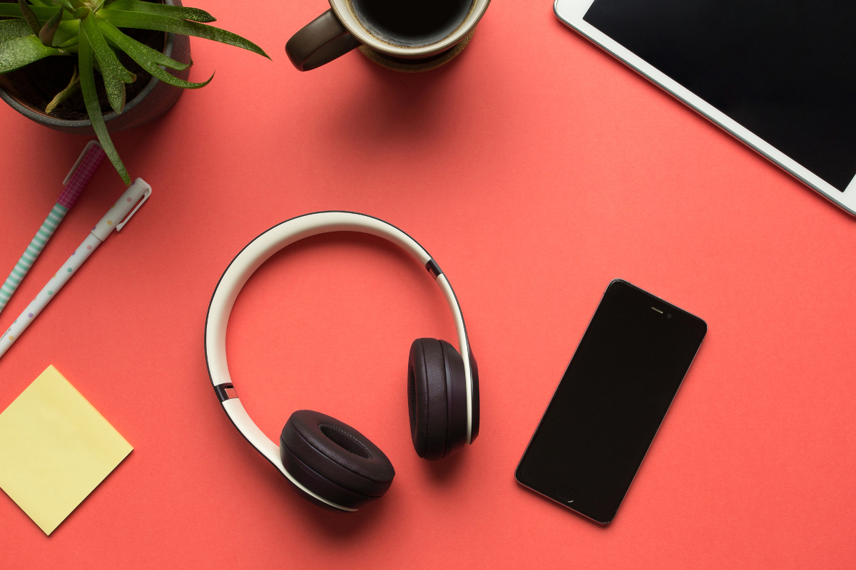 Smartphone and headphones representing 2010s music and technology for a 2010s quiz article