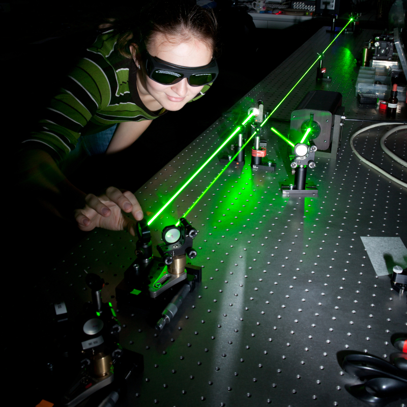 female scientist conducting a quantum optics experiment for a science trivia
