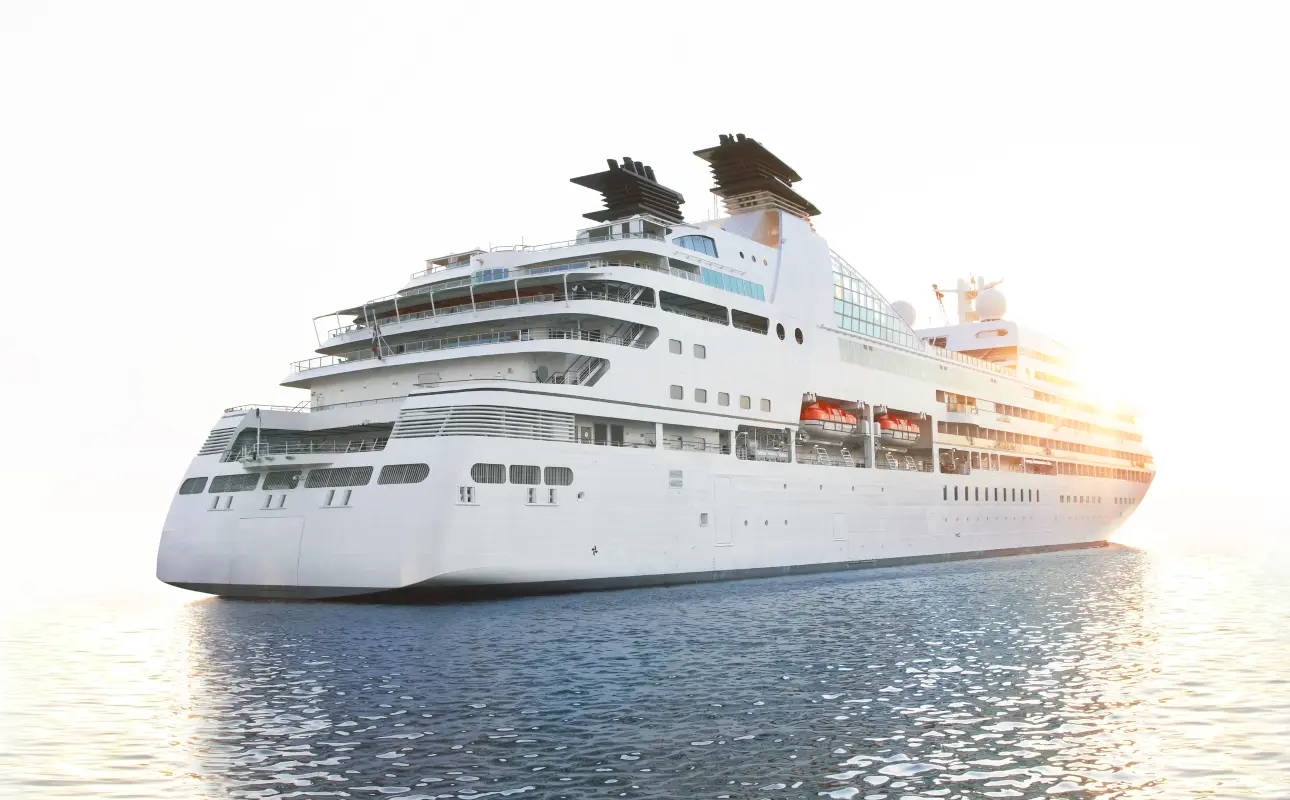 Large white cruise ship sailing on calm water