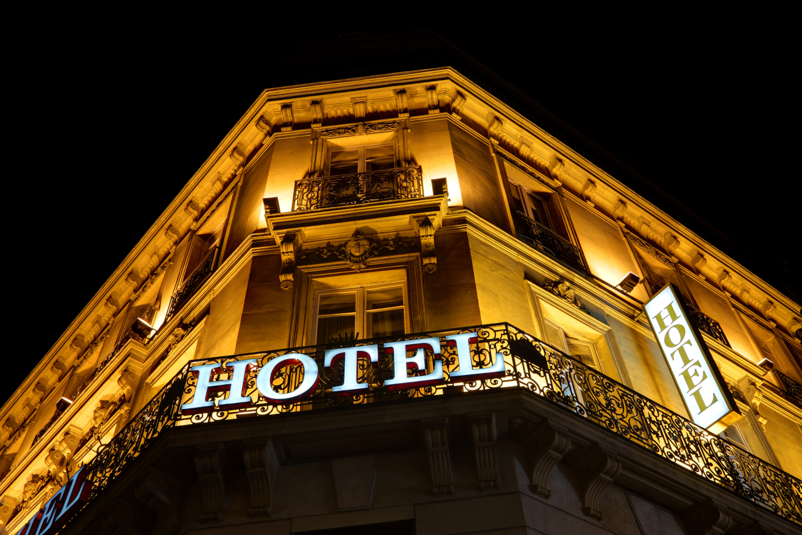 Illuminated hotel sign on a hotel building at night