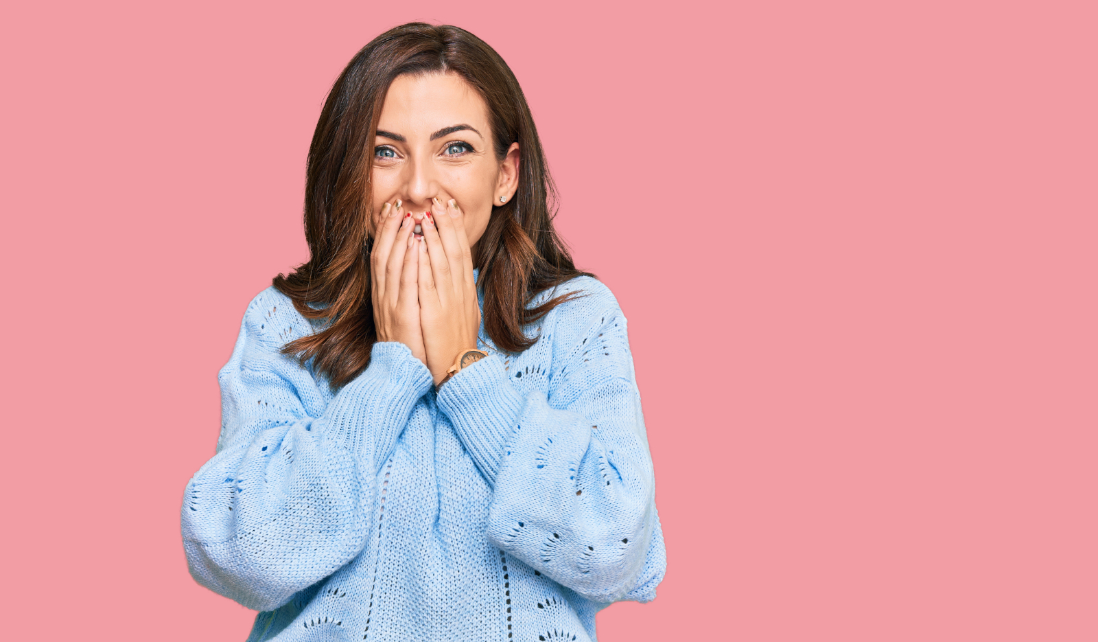 Embarrassed woman covering her mouth after an awkward moment