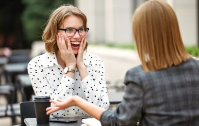 Woman reacting with excitement after hearing good news from a friend