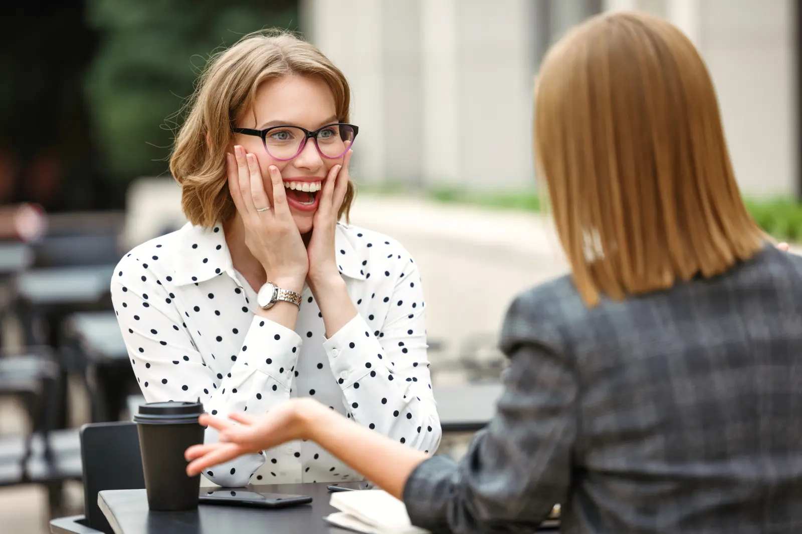 Woman reacting with excitement after hearing good news from a friend