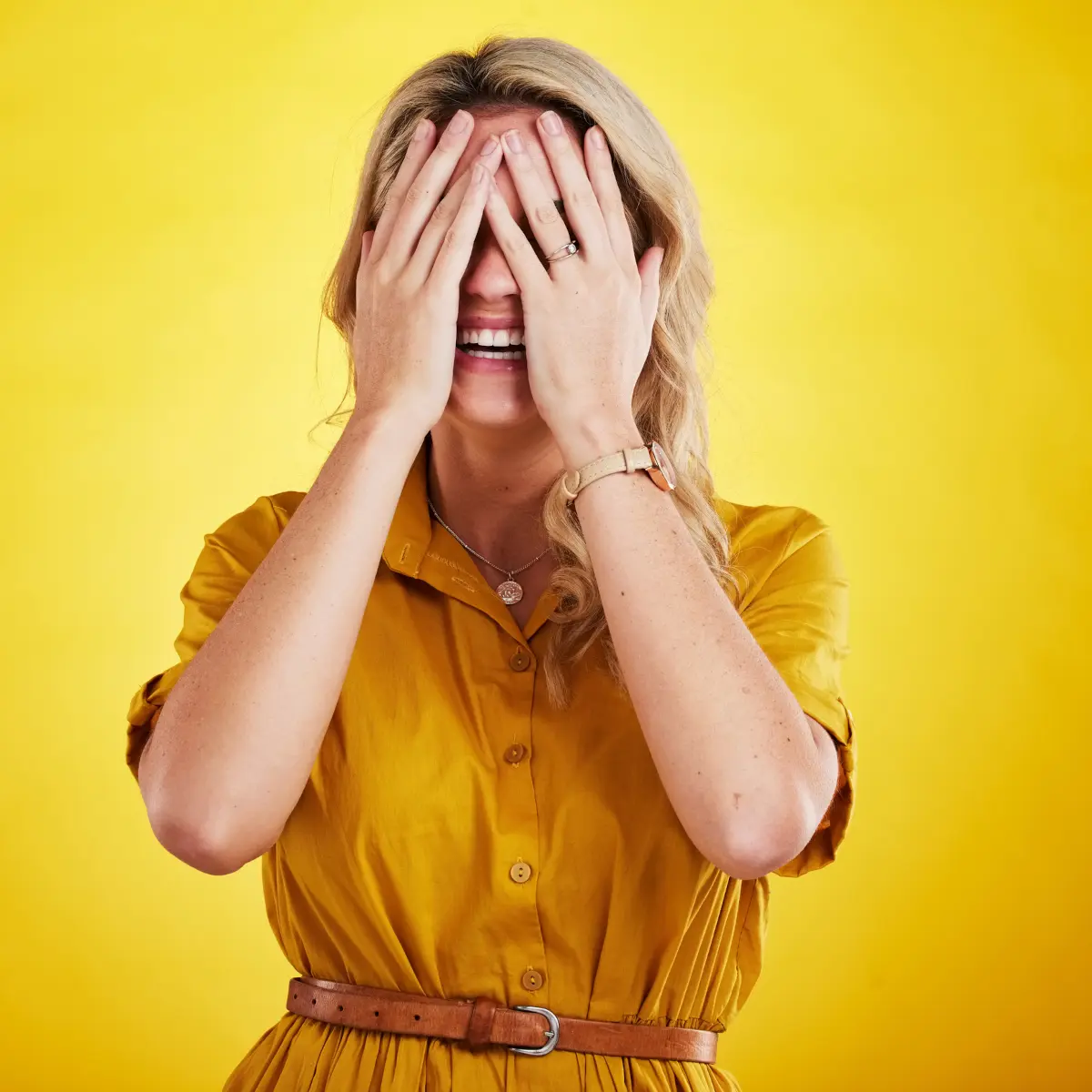 Woman facepalming after making an embarrassing mistake