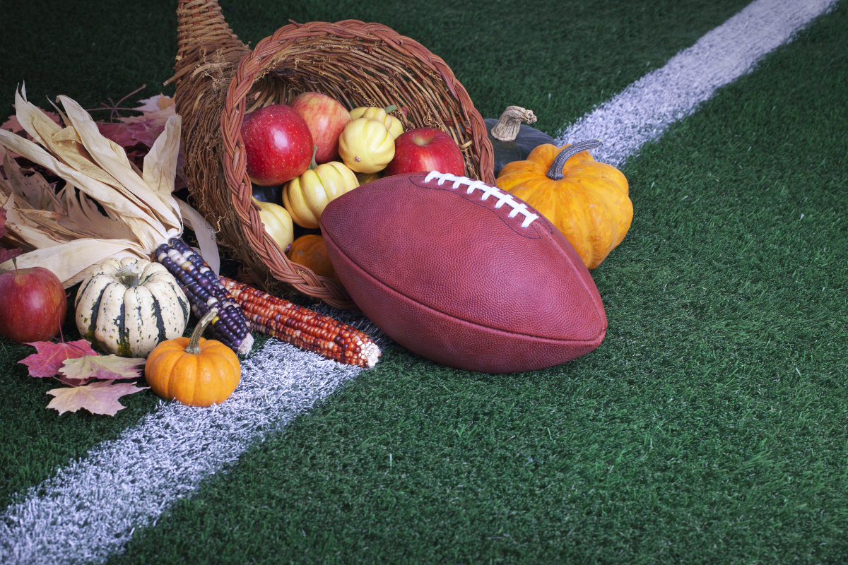 American football beside a cornucopia for Thanksgiving