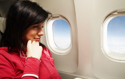 Woman sitting in a window seat on an airplane