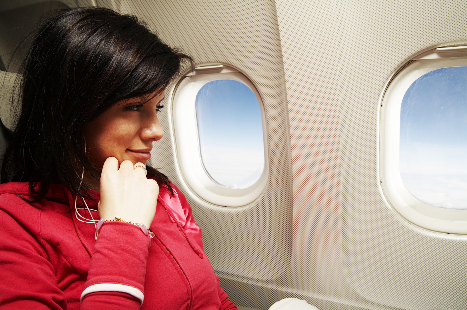 Woman sitting in a window seat on an airplane