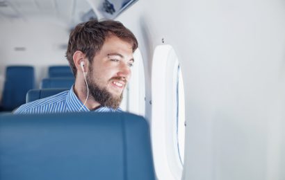 Man sitting by the window during an airplane flight