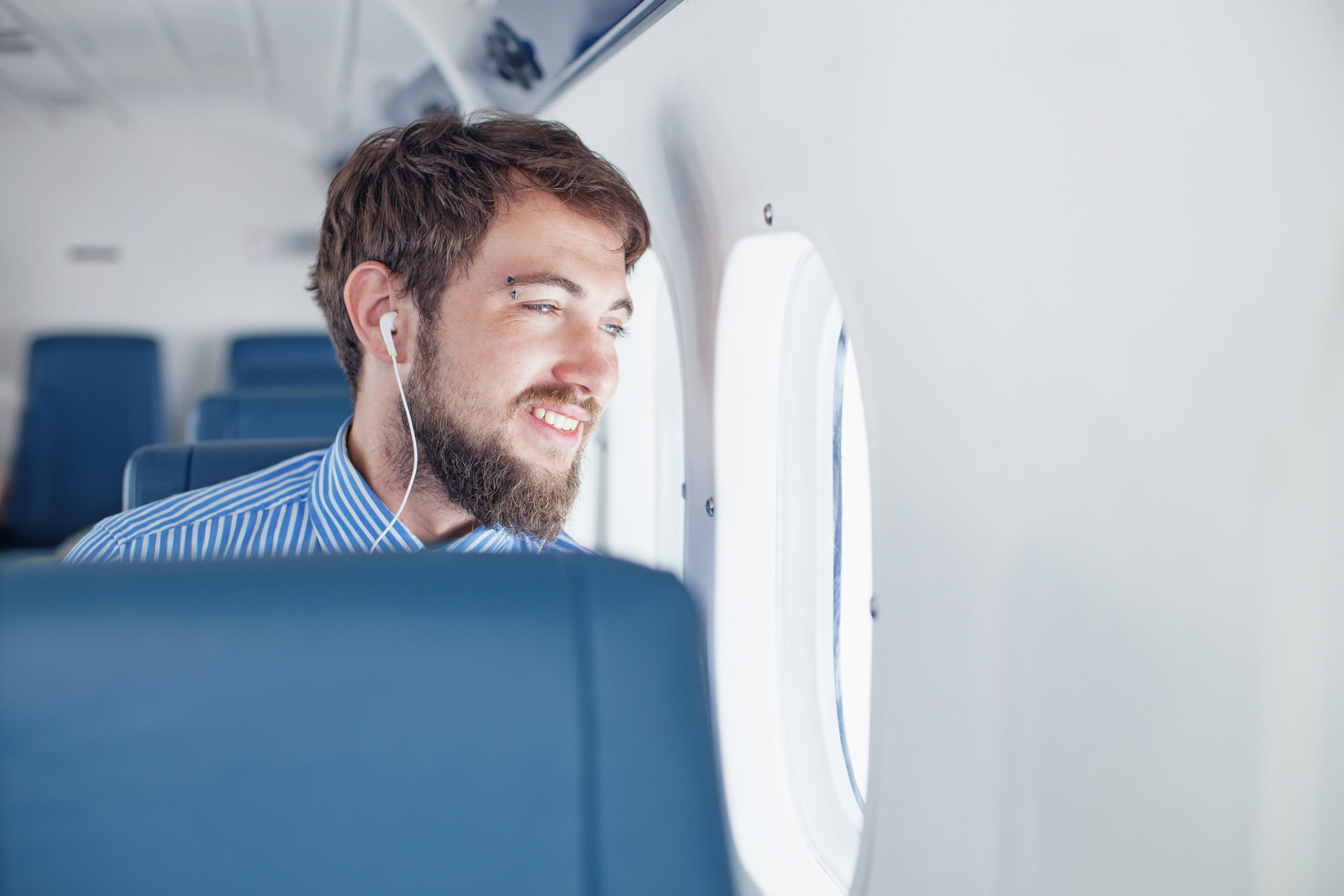 Man sitting by the window during an airplane flight