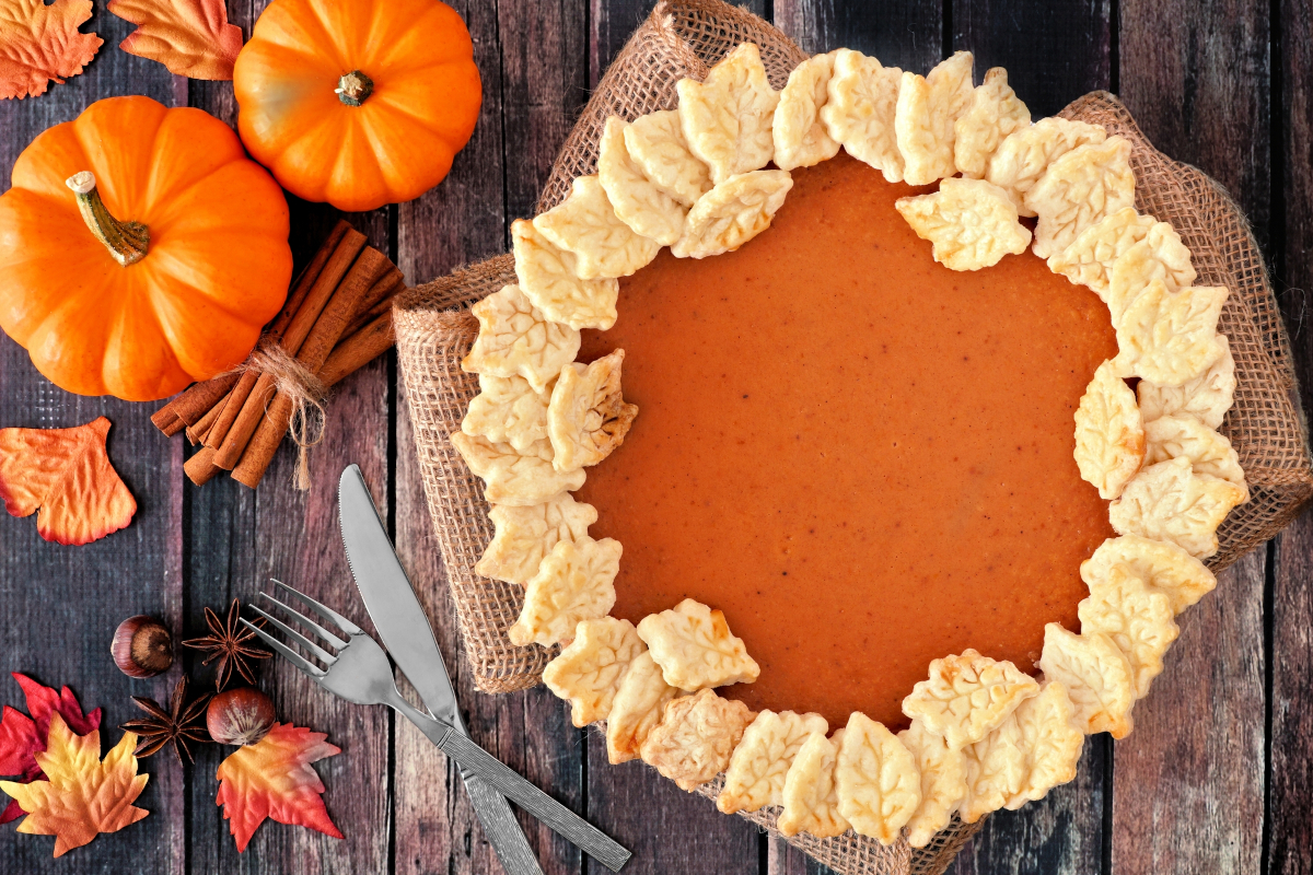 Pumpkin pie and puminks decor for a Thanksgiving trivia questions with answers