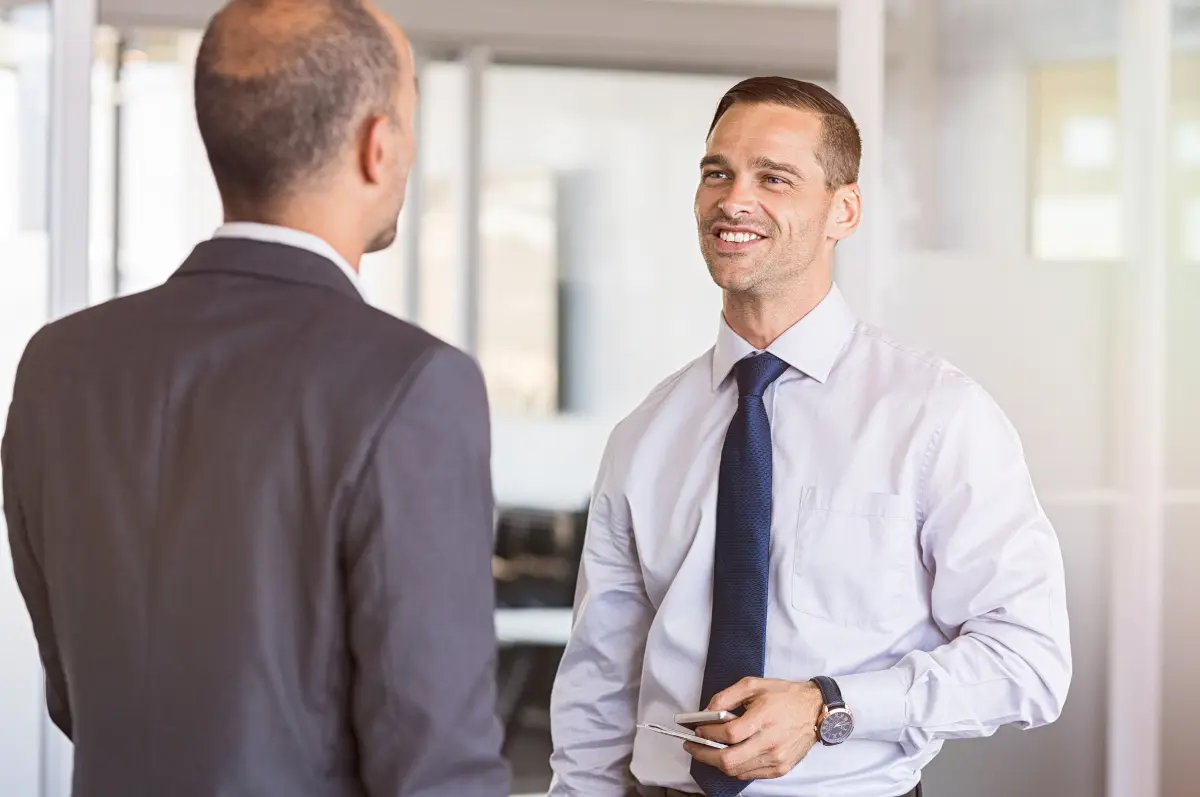 Two coworkers talking during a meeting at work