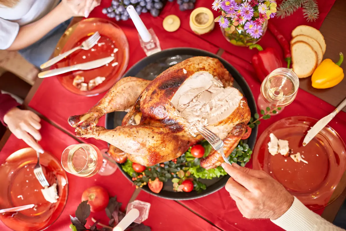 Roasted turkey and side dishes on a Thanksgiving family dinner table