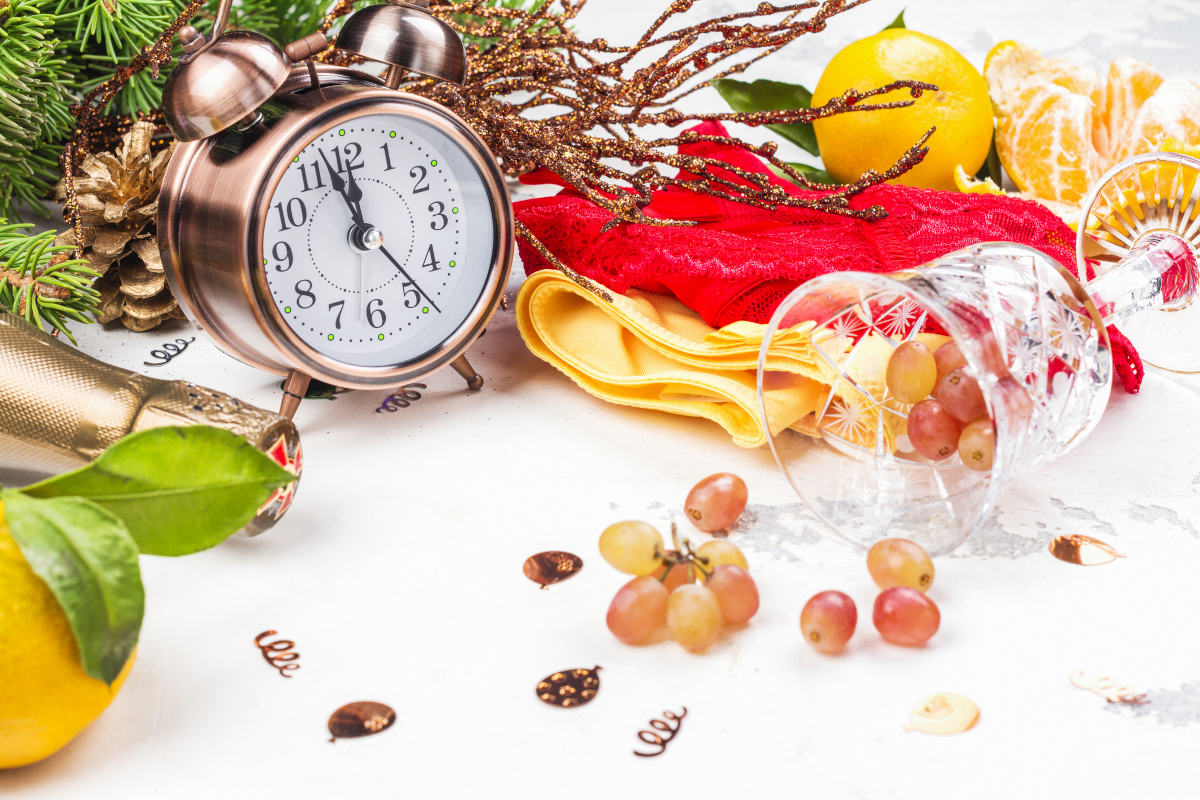 New Year lucky foods and traditions with grapes, lentils and symbolic items