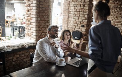 Restaurant customers arguing with a waitress at their table