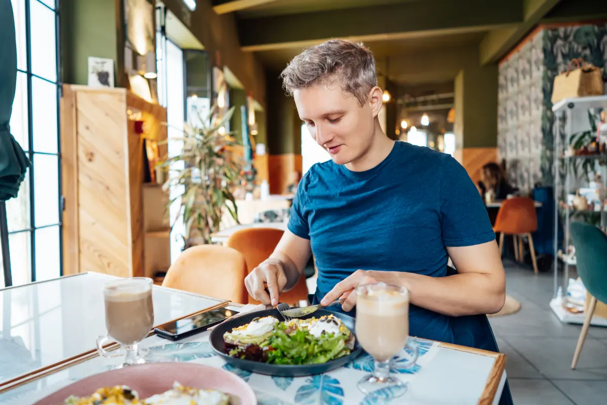 Young man having breakfast at the hotel.